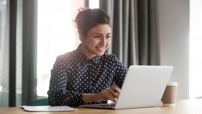 Woman at a laptop smiling